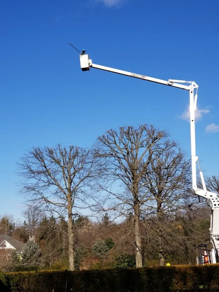 man in a bucket lift at work